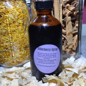 Elderberry syrup bottle with herbs and spices.