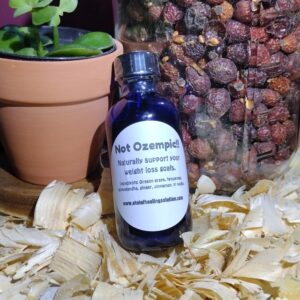 Herbal bottle with plant and dried berries.