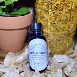 Plant, jar, and bottle on wood shavings.